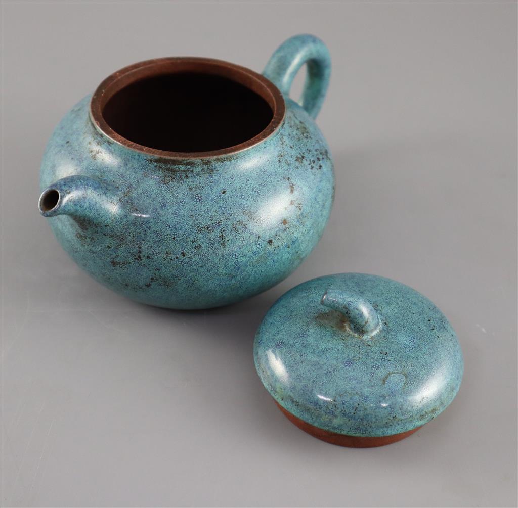 A Chinese Yixing robins-egg glazed compressed globular teapot and cover, Qing dynasty, 17.5cm across